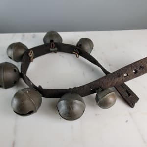 Antique Petal Sleigh Bells  Image: Wear in leather strap. 