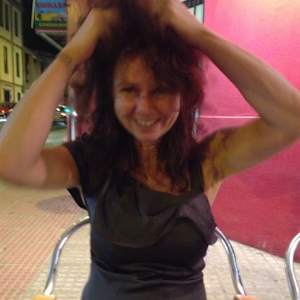 Susanne by Hanna Bordewijk  Image: My friend Susanne and me were on vacation in Spain about a decade ago. This photo I took of her on an evening out.  I had my camera out and was able to snap this happy 'free' picture of her ruffling her hair. 